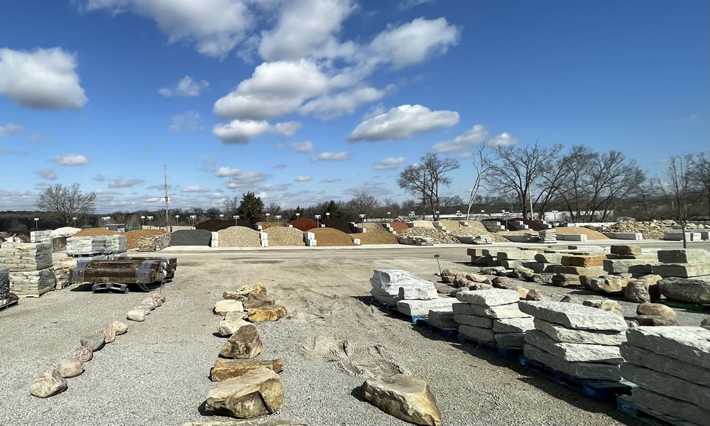 Image of the stone yard at Creech's Lawn & Landscape, showing bulk aggregate stone, boulders, and more